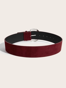 Detail of burgundy suede wide belt with vintage textured silver oval buckle