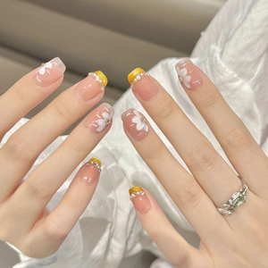 Handmade press-on nails with pink base, floral art, mini pearls, and rhinestones