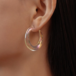 Close-up of iridescent acrylic C-shaped hoop earrings with holographic pearl finish