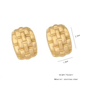 Detailed view of irregular geometric earrings with woven texture and product dimensions