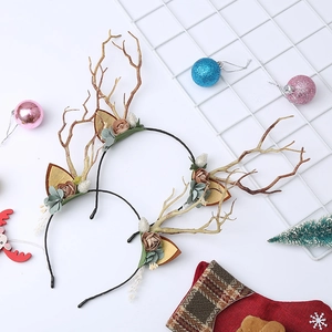 Detail of Christmas reindeer antler headband with festive flowers and gold ornaments