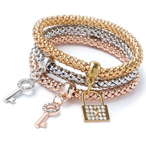 Detailed close-up of three-piece stretch popcorn chain bracelets with heart lock pendants