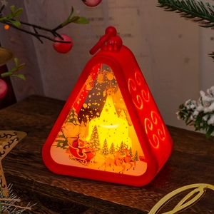 Detail of red vintage Christmas lantern with LED light and festive reindeer scene