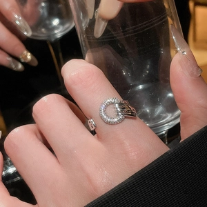 Close-up of geometric circular open ring featuring sparkling pavé zircon on silver finish