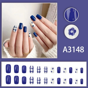 Klein blue plaid press-on nail set with white floral patterns and glossy finish