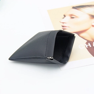 Detail of matte black pouch showing the automatic squeeze closure and soft leather texture
