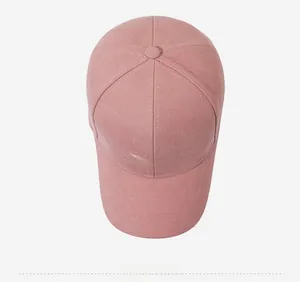Detail view of pink cotton baseball cap featuring white Share letter embroidery and texture
