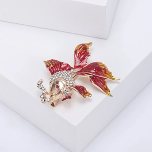 Detail shot of goldfish brooch with red enamel, crystal scales and gold-tone finish