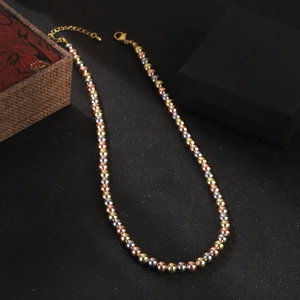 Three-tone beaded necklace in gold, silver, and rose gold with adjustable lobster clasp chain