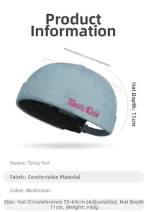 Detail of light blue denim docker hat featuring red Music Club embroidery and metal buckle
