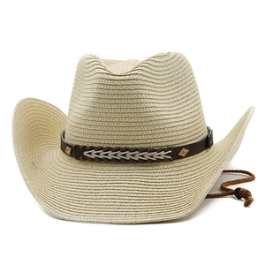 Detail of wide brim straw cowboy hat with brown faux leather band and metal rivets