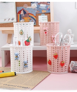 Close-up of cute woven texture plastic pen holders with strawberry and bear decorations