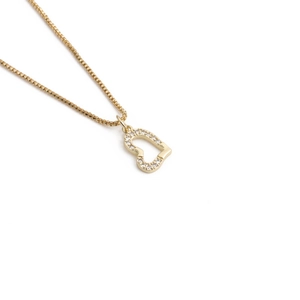 Detailed view of a gold-plated copper heart pendant with sparkling cubic zirconia inlay