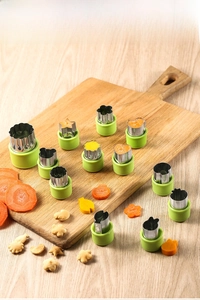 12-piece stainless steel fruit cutters with green grips on a wooden board scene