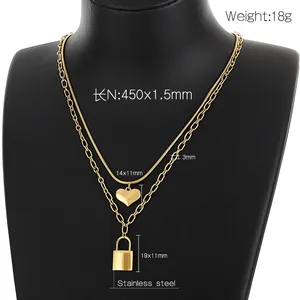 Detailed view of layered stainless steel gold heart and lock pendant necklace with dimensions