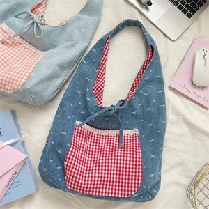 Close-up of denim shoulder bags with bow patterns and lace-trimmed gingham pockets
