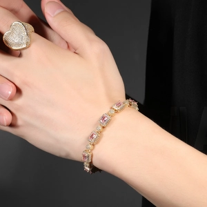 Close-up of gold ring with large heart-shaped pink stone and paved cubic zirconia
