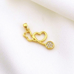 Macro detail of gold heart stethoscope pendant with sparkling cubic zirconia settings