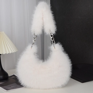 White faux fur crossbody bag with silver chain strap shown in a minimalist studio setting