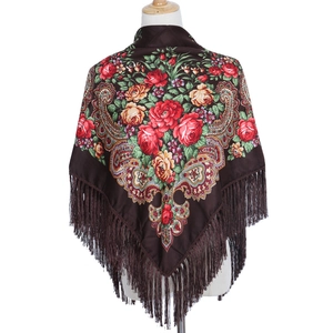 Detail of coffee brown shawl featuring large red roses, yellow flowers and long fringe