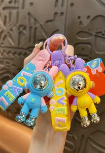 Detailed view of colorful blue and yellow astronaut rabbit keychains made of PVC and alloy