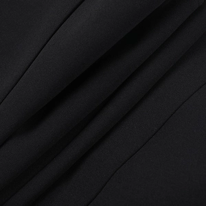 Macro shot of high-quality black knitted fabric with fine texture and smooth drape