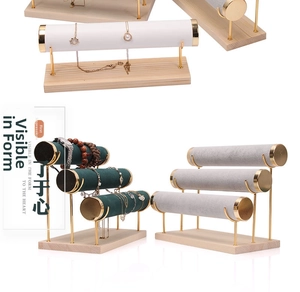Detail of velvet T-bar jewelry display stands with wooden base and gold metal frame