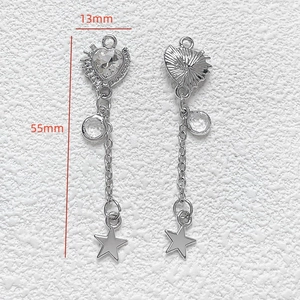 Detailed view of silver heart tassel pendant with star charm and 55mm length scale