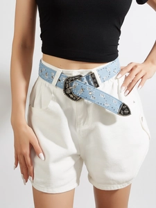 Detail of light blue denim belt with rhinestones and western engraved buckle on model