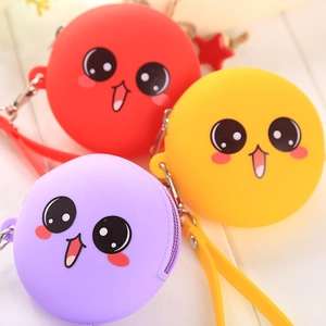 Close-up of colorful round silicone coin purses with cute cartoon faces and wrist straps