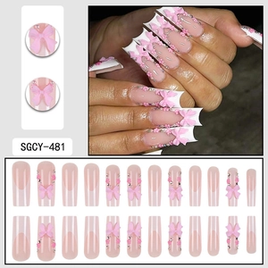French long press-on nails set with pink 3D bows, flowers, and crystal accents