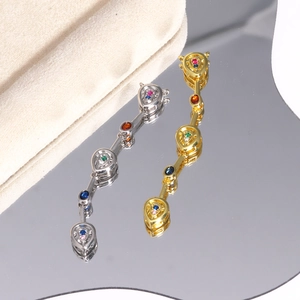 Detailed macro view of gold and silver tassel pendants with colorful teardrop zircon gems
