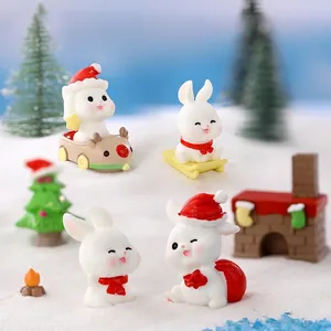 Miniature Christmas bunny resin figures featuring sledding and gift bag holiday designs