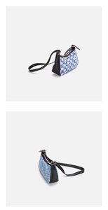 Detail view of denim underarm bag with blue and white plaid fabric and black leather trim