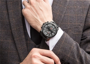 Close-up of men's multifunction quartz chronograph watch worn with a plaid business suit