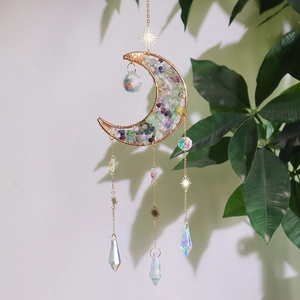 Detailed view of crescent moon crystal suncatcher with gold chains and hanging prisms