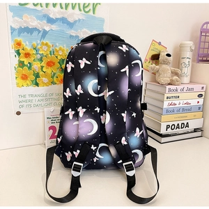 Back view of school backpack with star and butterfly print and padded straps