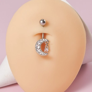 Silver crescent moon belly button ring with crystal star pendant on a model display