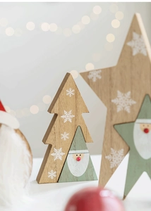 Macro detail of Nordic wood Christmas tree and star ornaments with snowflake patterns