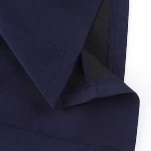 Macro shot of high-quality sewing and stitching details on a navy blue long sleeve dress