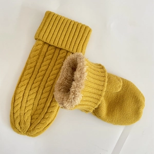 Detailed close-up of yellow knit thermal socks with warm faux fur lining texture