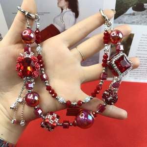 Macro detail of red beaded charm with crystal beads and traditional double happiness motif