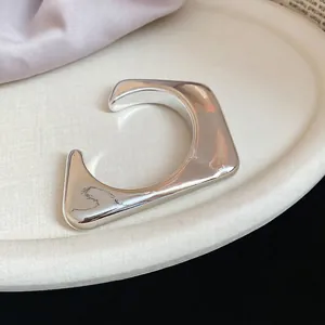 Polished silver irregular geometric open C-shaped cuff bracelet with mirror finish