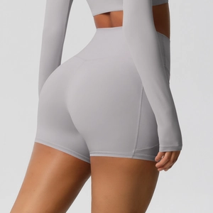 Detail showing high-waist compression fitness shorts in light gray with seamless texture