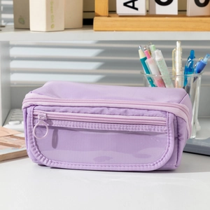 Detail view of purple multi-layer pencil case with clear window on a desk