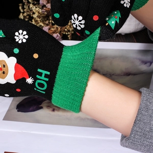 Women's warm winter knitted Christmas gloves with Santa and tree motifs in black and green