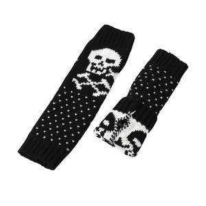 Knitted arm warmers with white skull and polka dot patterns on black acrylic fabric