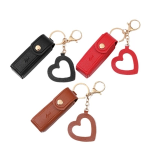 Mini leather lipstick case keychain in black, red, and brown with a gold heart pendant