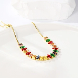 Detail view of gold adjustable bracelet with colorful marquise-cut sparkling zircons