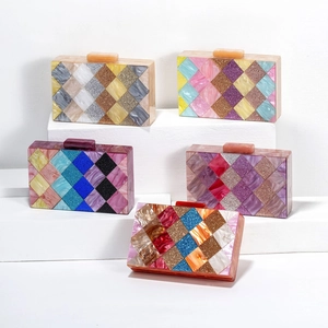 Detailed close-up of acrylic evening clutch bags with colorful diamond pattern and glitter